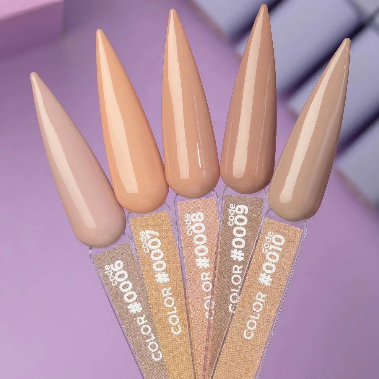 Five DNKa' Gel Polish nail swatches side by side showing Color #0006 through #0010, a gradient of warm nude to brown tones, on a purple background
