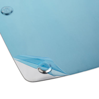 Close-up of a reflective silver base plate for UV/LED nail lamp, partially covered with protective blue film